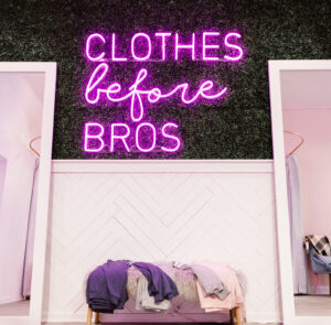 Clothes before Bros neon sign