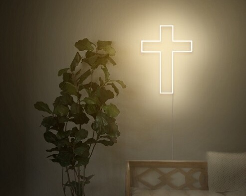 A spiritual neon sign of a cross to show the love for your religion