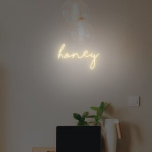 Honey-themed neon sign with a buzzing design