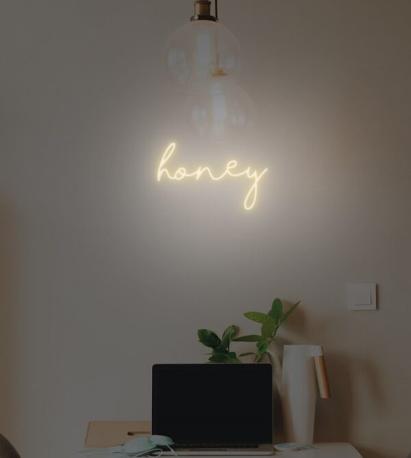 Honey-themed neon sign with a buzzing design
