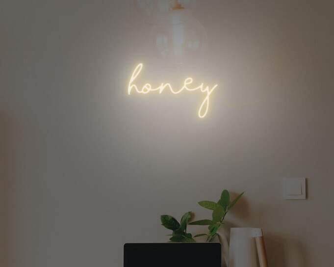 Honey-themed neon sign with a buzzing design