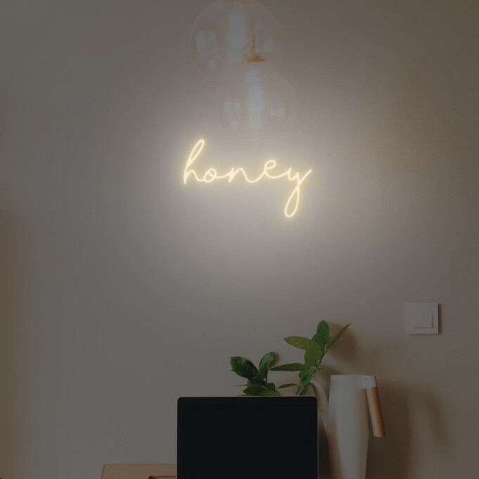 Honey-themed neon sign with a buzzing design