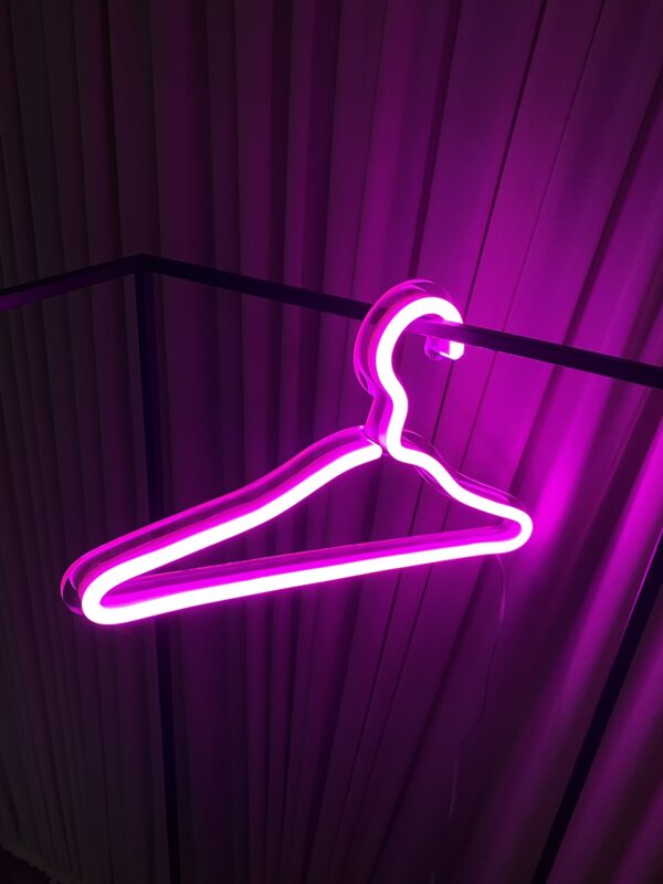 clothes hanger neon sign pink