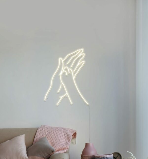 A cute and charming neon sign of a paw print and hand shape for your bedroom