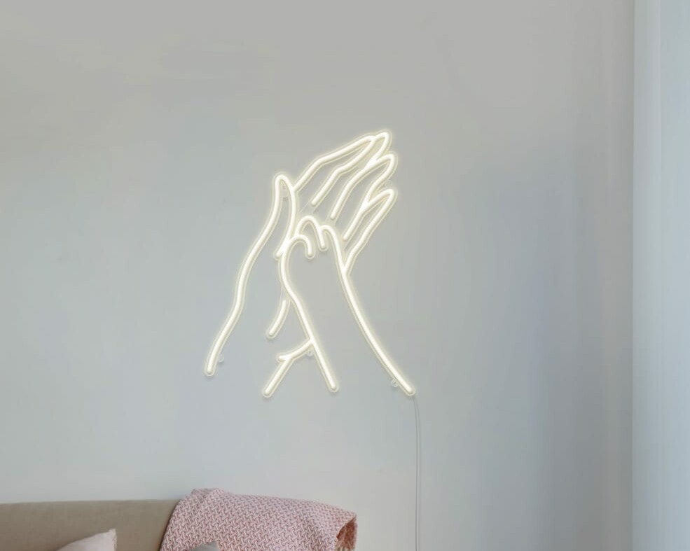 A cute and charming neon sign of a paw print and hand shape for your bedroom