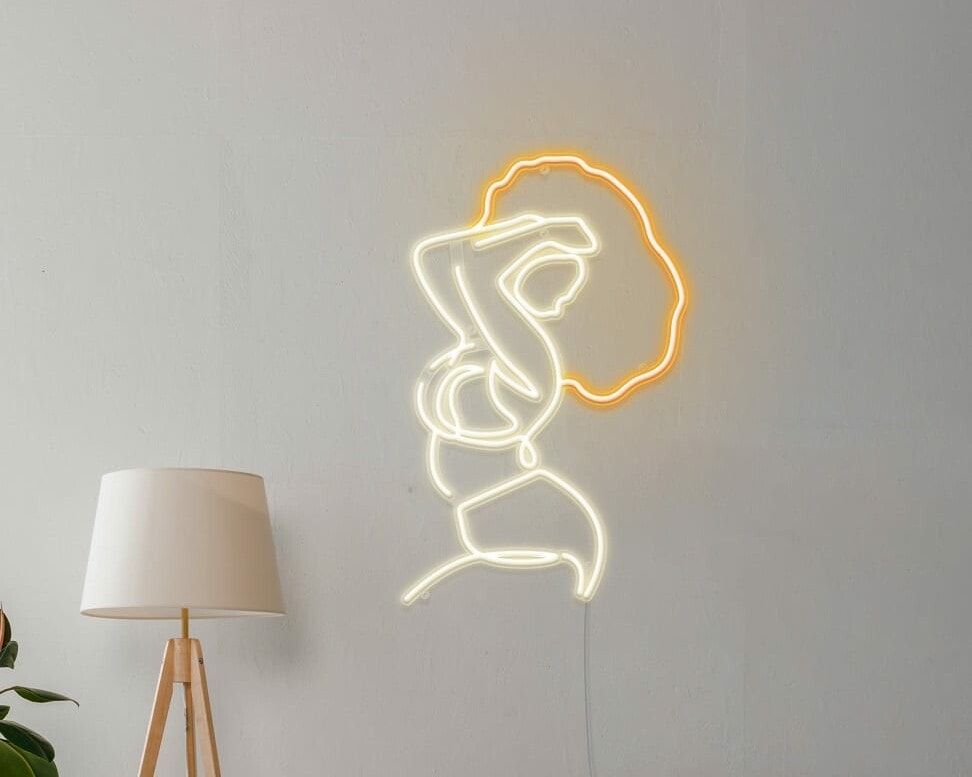 A playful neon sign of a woman striking a pose on a wall