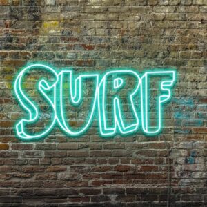 A personalized neon sign of the word 'surf' on a brick wall