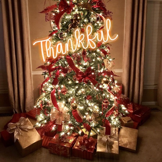 Thankful letter neon sign on lighting Christmas tree