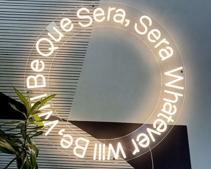 soft white custom neon sign que sera sera. custom quote neon sign