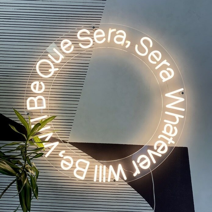 soft white custom neon sign que sera sera. custom quote neon sign