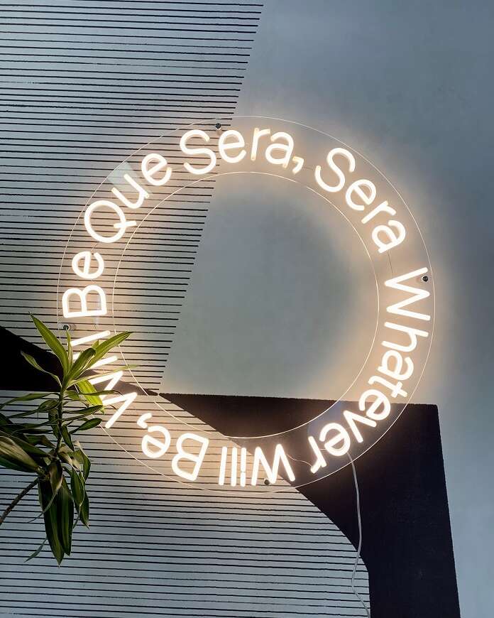soft white custom neon sign que sera sera. custom quote neon sign