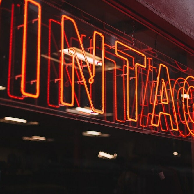 Vintage neon sign mirror on glass wall