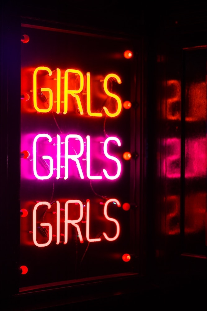 girls orange pink and red glass neon sign
