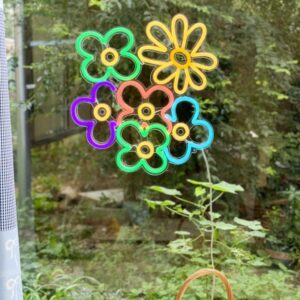 Daisies multi color neon sign by the window