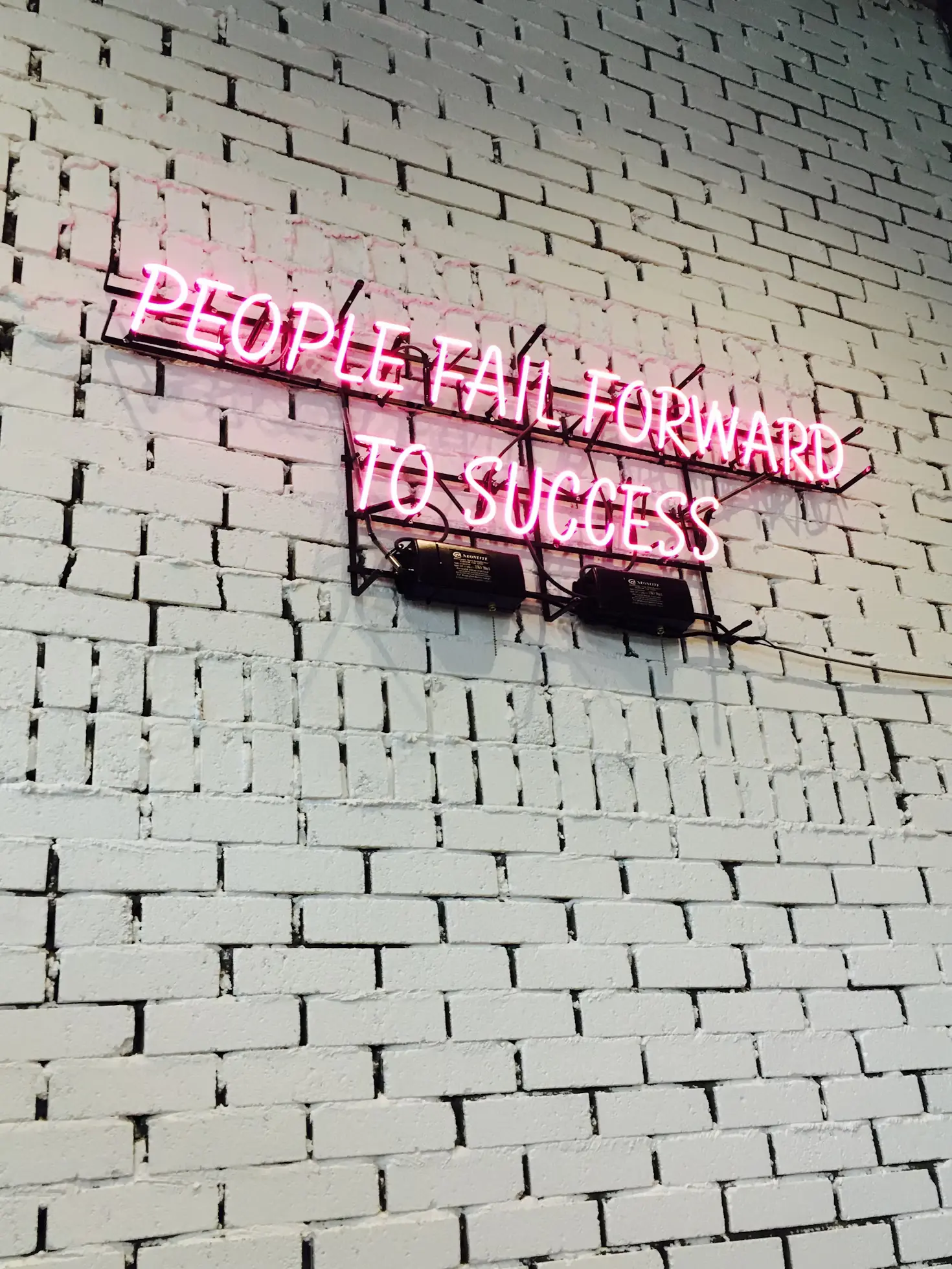 people fall forward to success pink quote neon sign