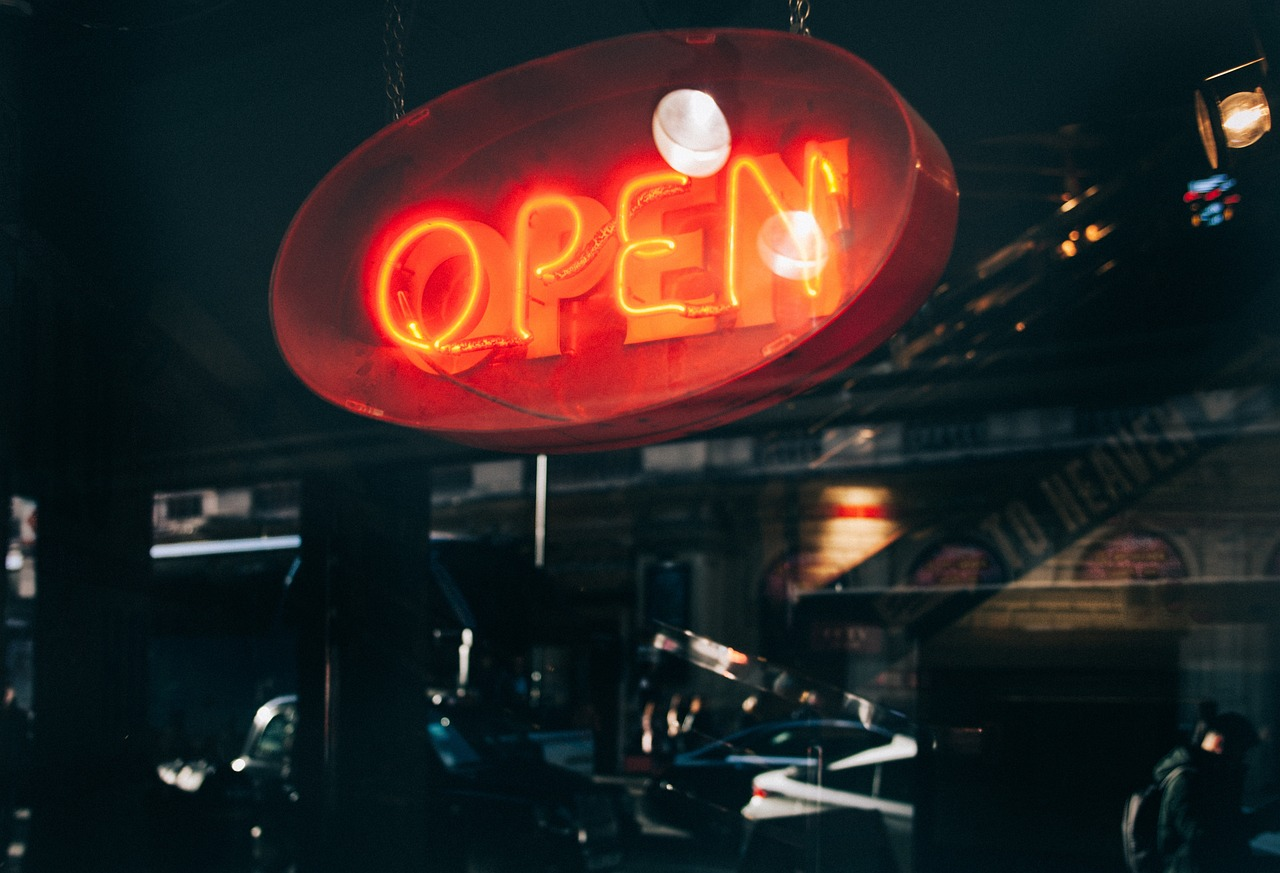 open red glass neon sign by the window