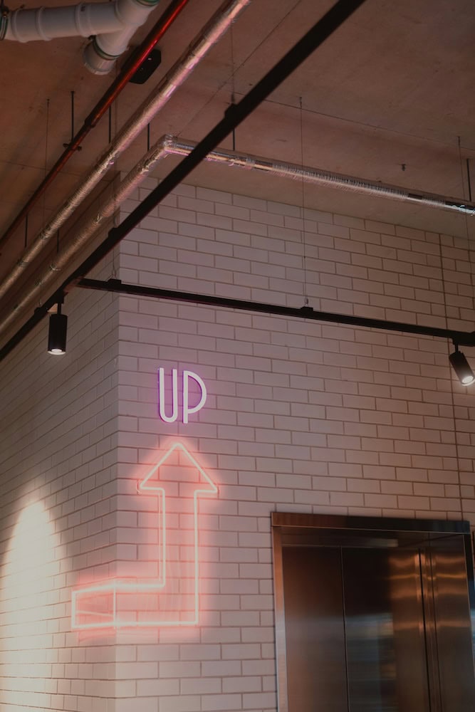 arrow up indication pink neon sign