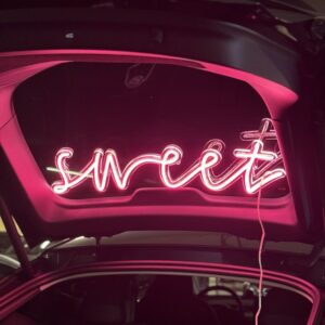 sweet pink neon sign in trunk