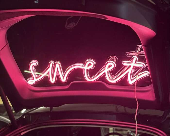 sweet pink neon sign in trunk