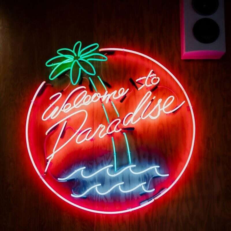 glass neon party sign welcome to paradise