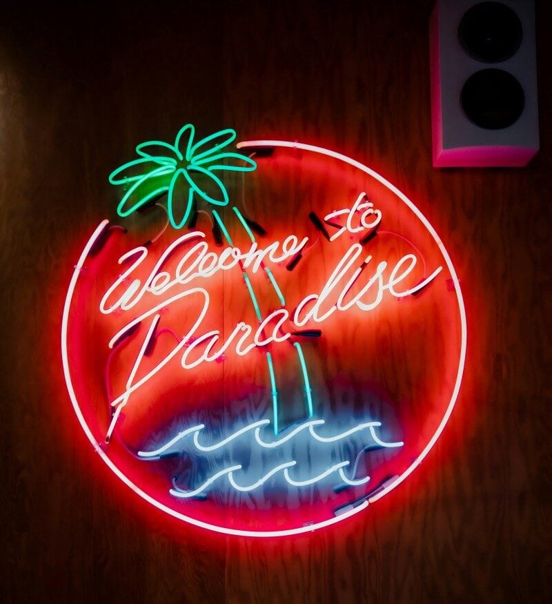 glass neon party sign welcome to paradise