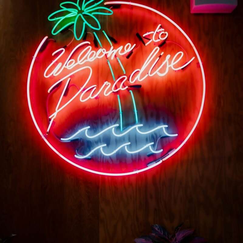 glass neon party sign welcome to paradise