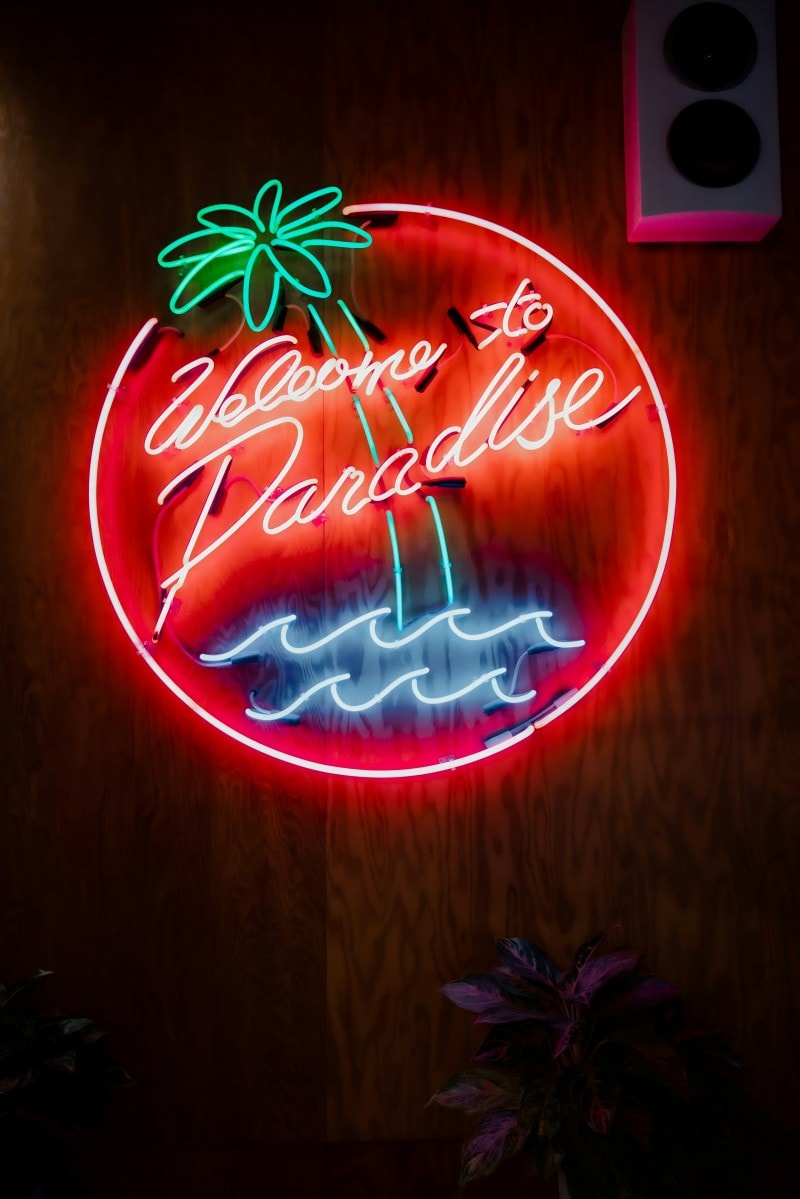 glass neon party sign welcome to paradise