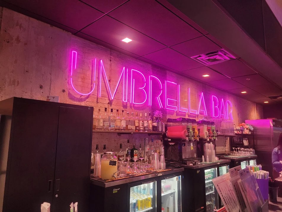 unbrella bar atlanta with pink LED neon sign