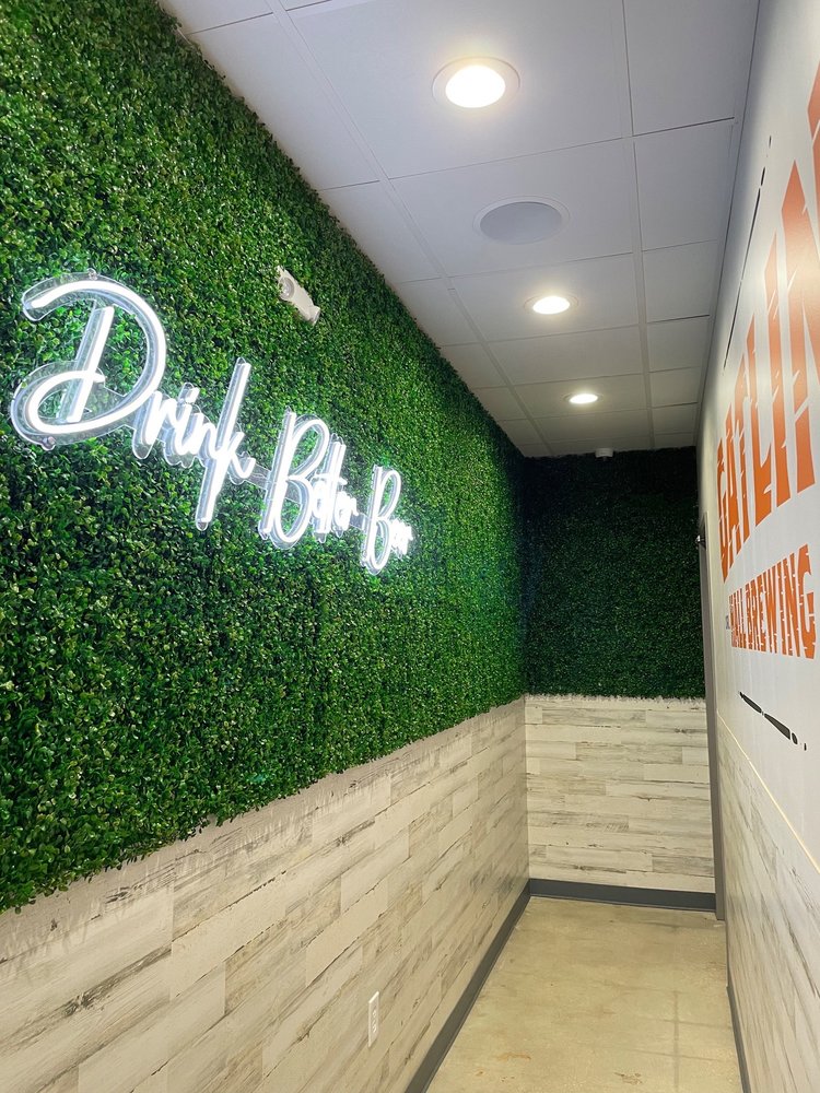 Gatlin Hall Brewing white led neon sign on faux green wall