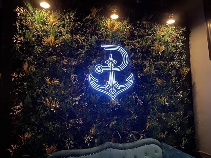 led blue anchor shaped neon sign in bar