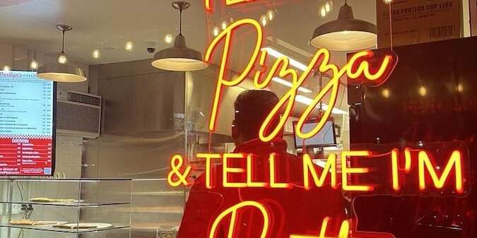 marilyn's pizza feed me pizza restaurant neon sign