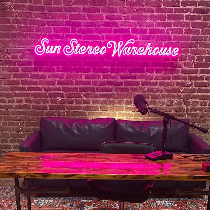 podcast setup custom neon sign as backdrop
