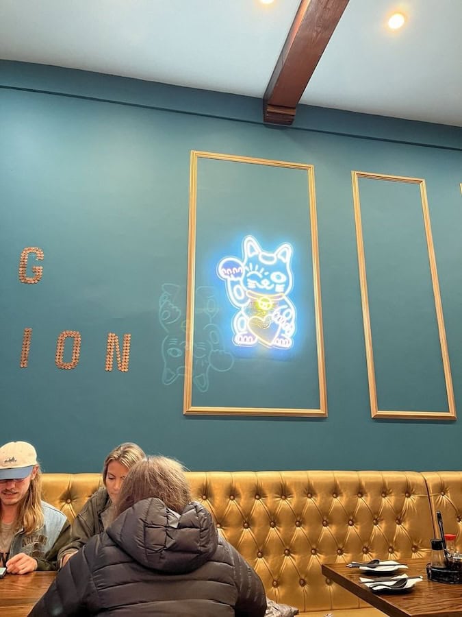 maneki-neko lucky cat neon sign in Dumpling Union restaurant neon signs in San Francisco