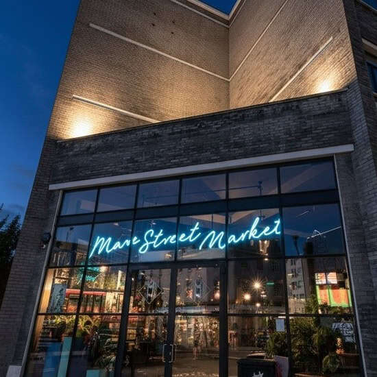 Blue custom neon sign for a deli and neighborhood market