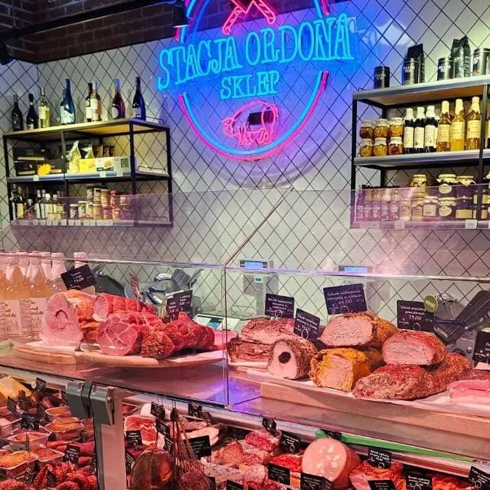 Colorful custom deli neon sign with a circular logo