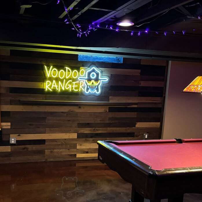 Colorful neon logo sign for a basement pool room