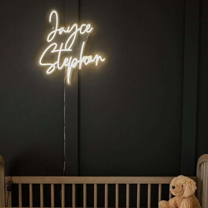 Custom nursery neon sign with a baby’s full name in warm white