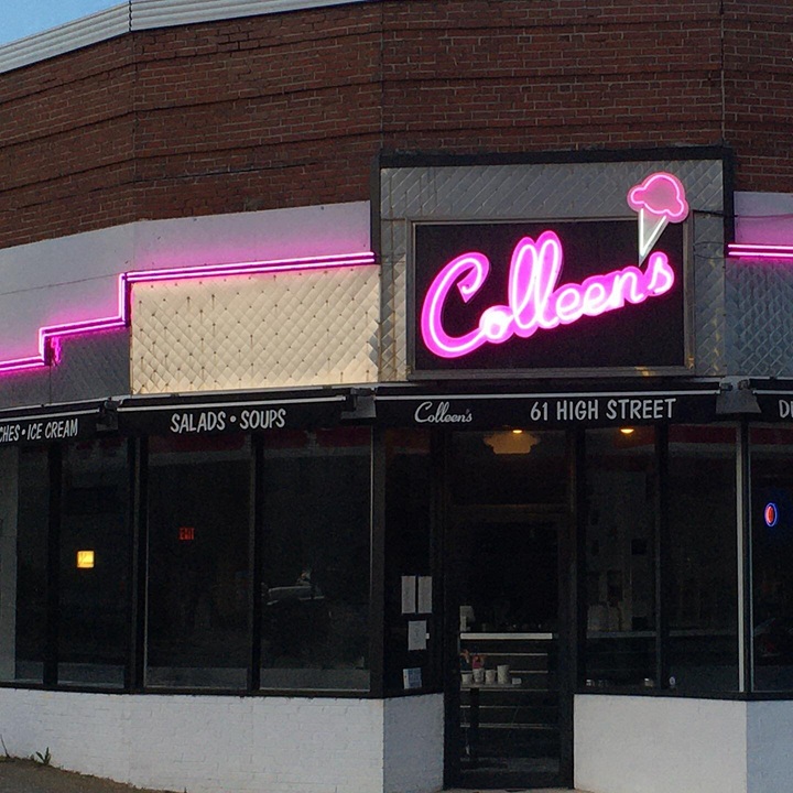 Custom pink ice cream shop neon logo sign on a storefront