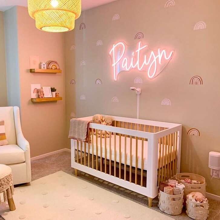 Custom pink neon name sign for a nursery with pastel decor