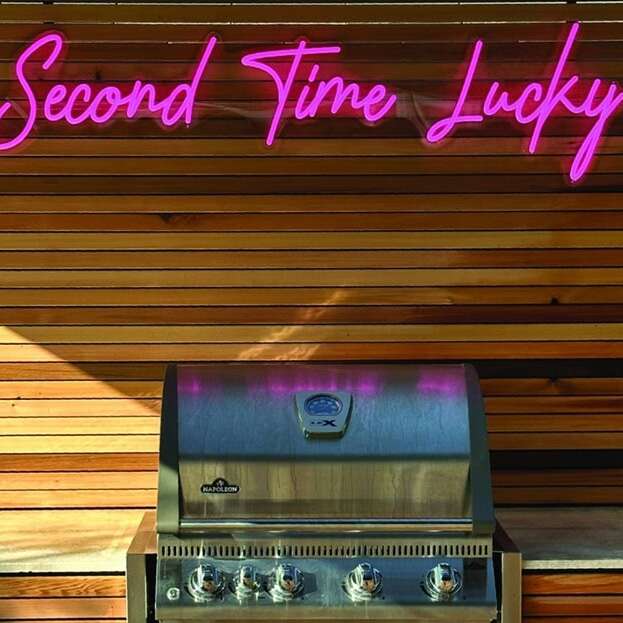 Custom pink neon sign for an outdoor kitchen