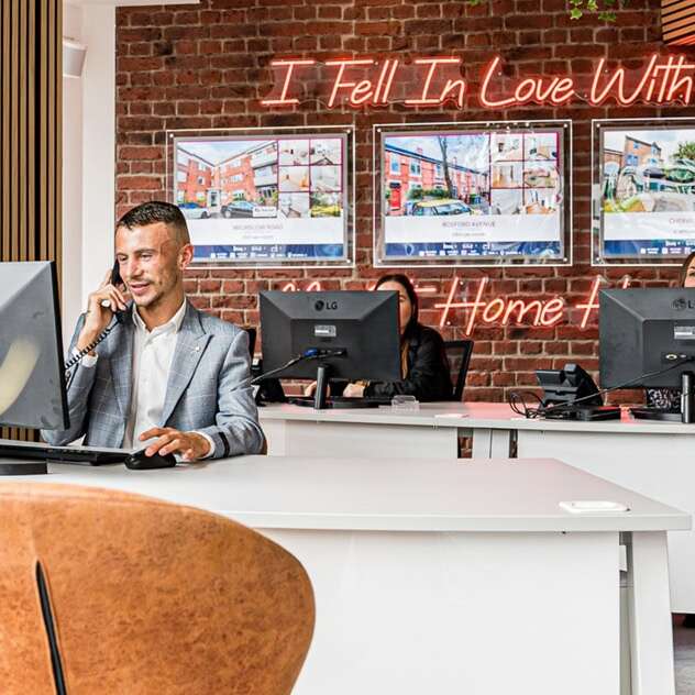 Custom script neon sign for a real estate office in coral red