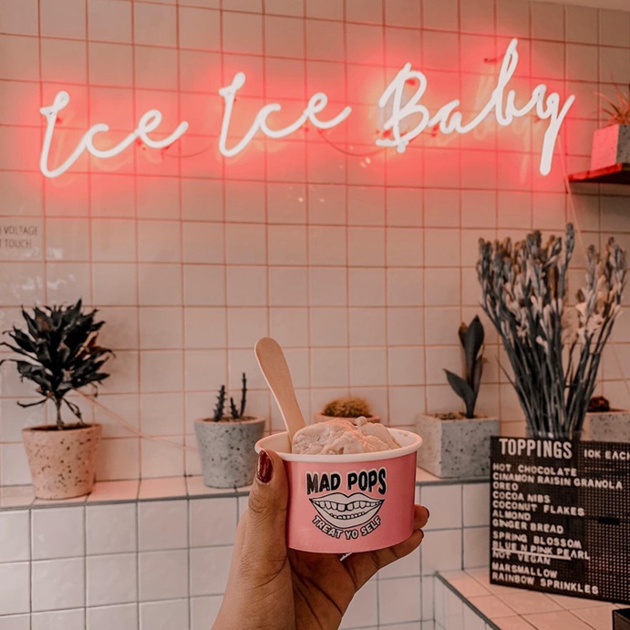 Ice Ice Baby real glass neon sign above an ice cream shop counter