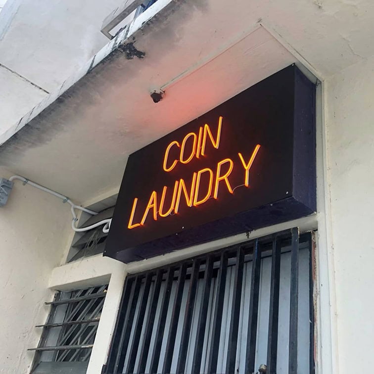 Orange coin laundry neon sign with classic lettering