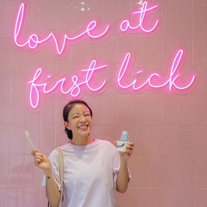Pink Love at First Lick led neon sign on an ice cream shop wall