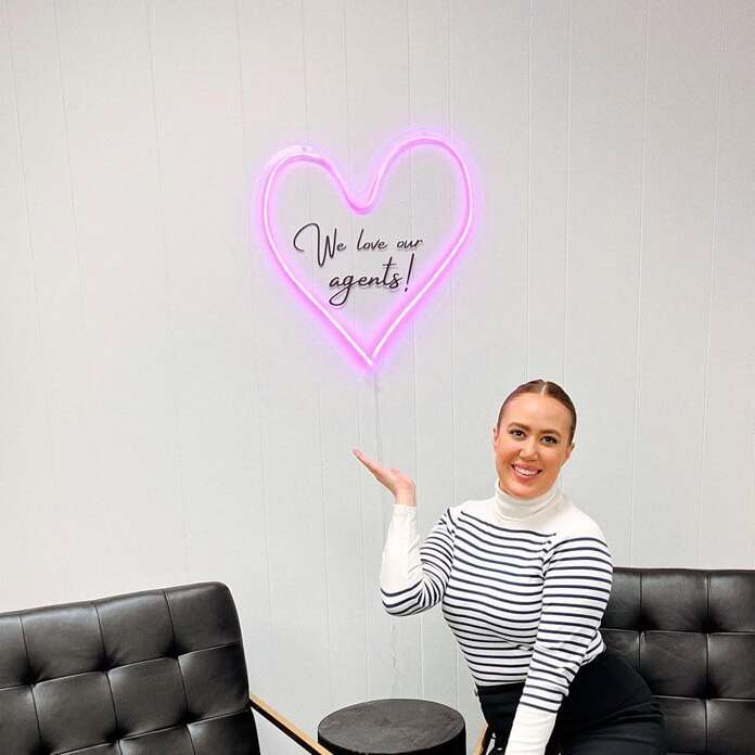Pink heart neon sign for a real estate office