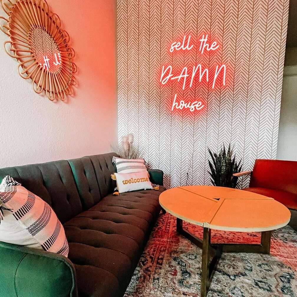 Playful red neon quote sign for a real estate agency