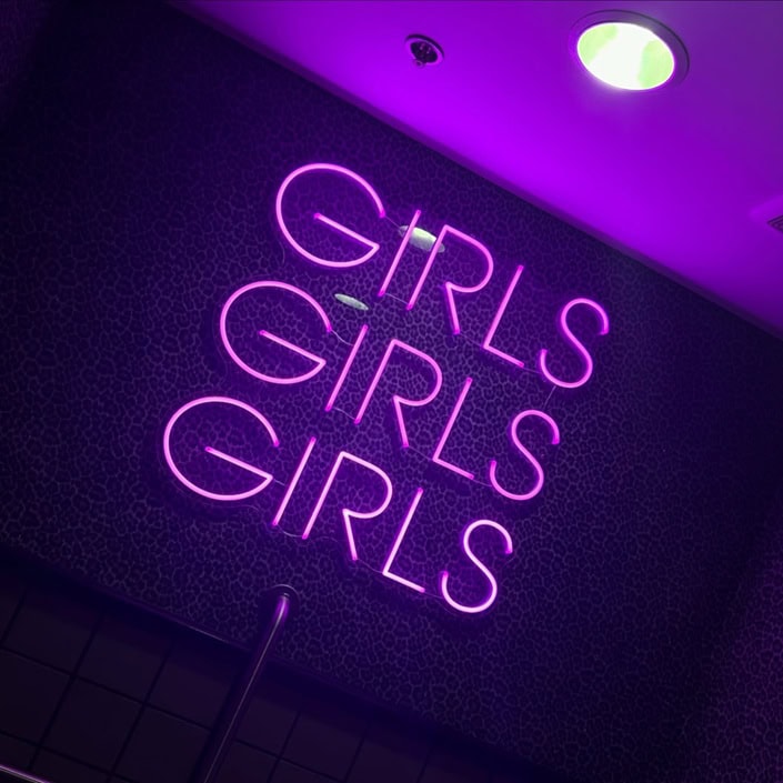 Purple Girls Girls Girls neon sign for a bold bathroom wall