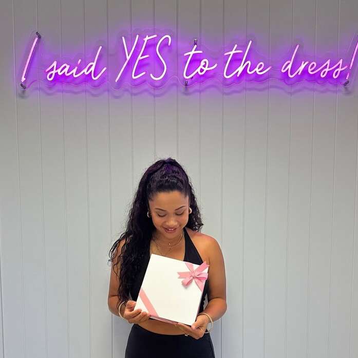 Purple I Said Yes to the Dress neon sign in a bridal shop
