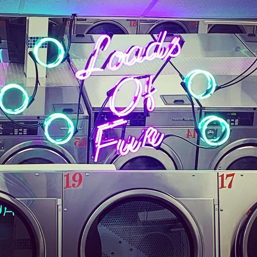 Purple laundromat glass neon sign with colorful bubble designs