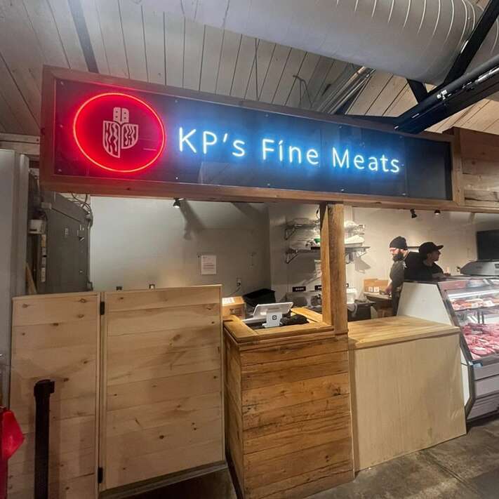 Red and blue custom neon logo sign for a meat shop